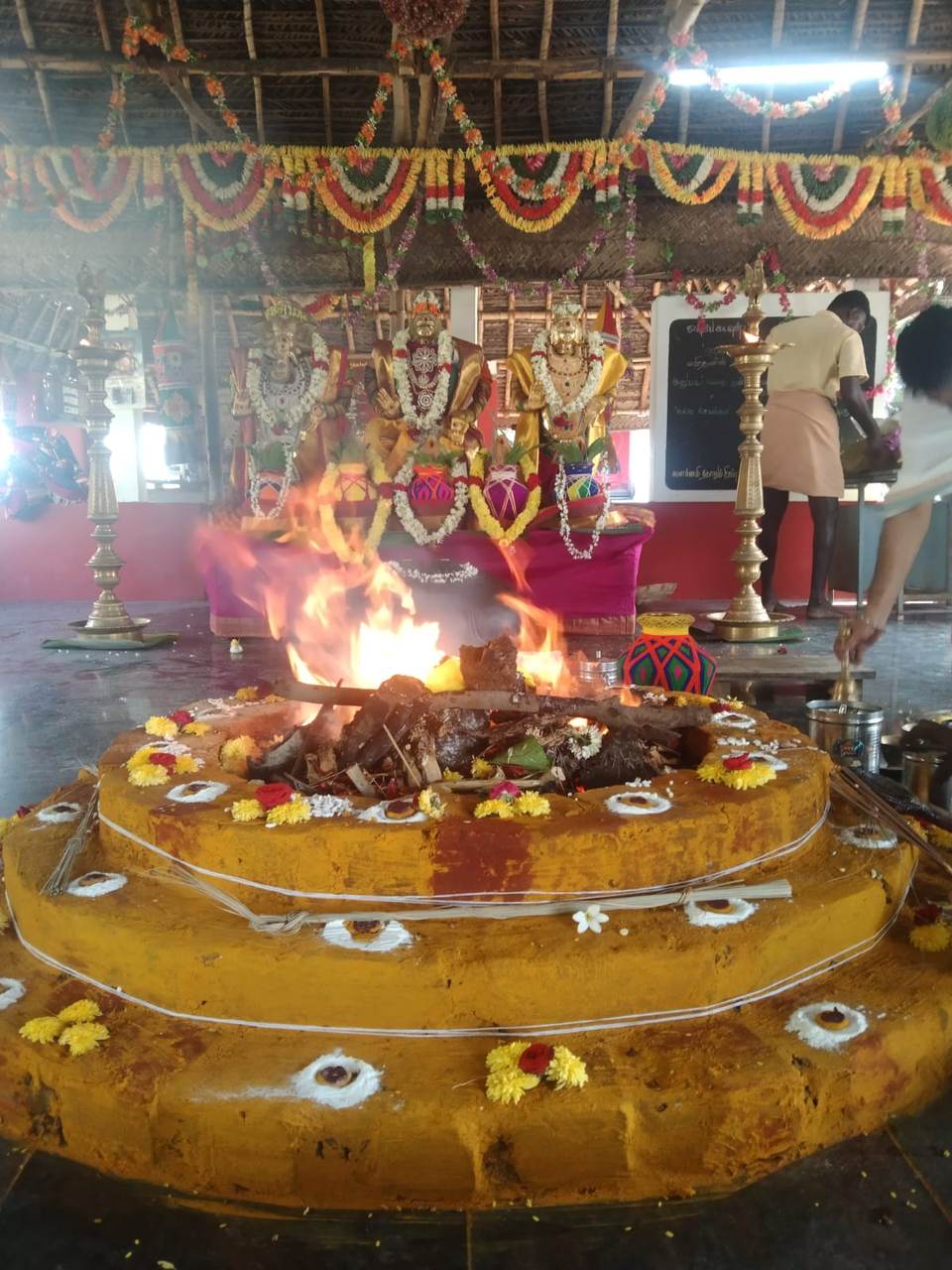 Sacred fire ceremony before the temple's golden deities