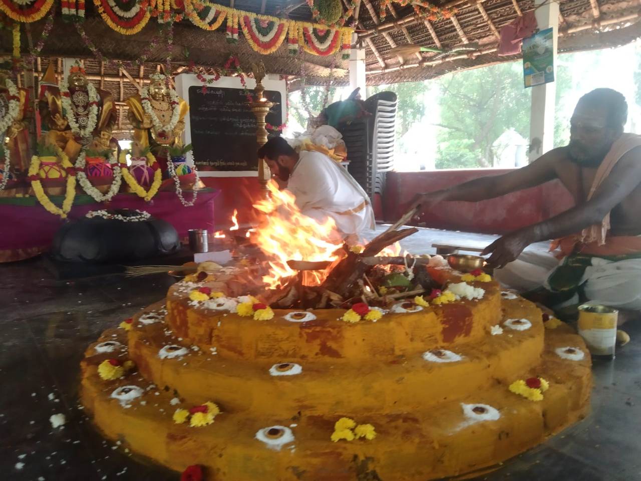 Priests conducting the homam together before the temple deities