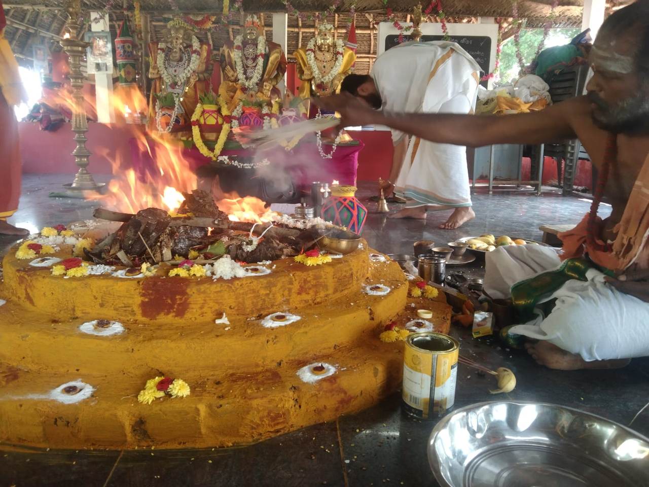 Priest offering sacred items into the homam fire