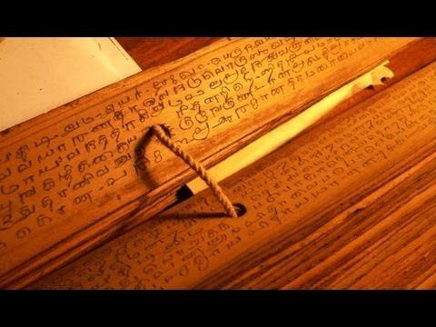 Magnifying glass over an ancient palm leaf manuscript